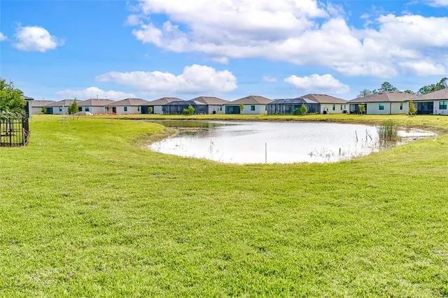 a view of a lake with houses in the background