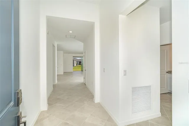 a view of a hallway with wooden shelves