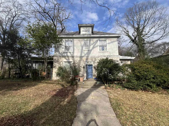 a view of a street with a building in the background