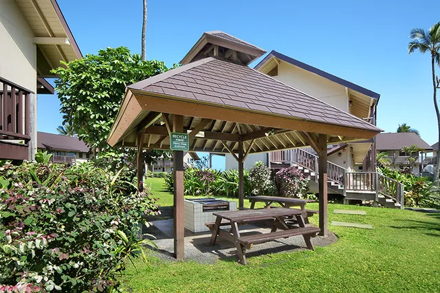 a view of patio with a table and chairs under an umbrella