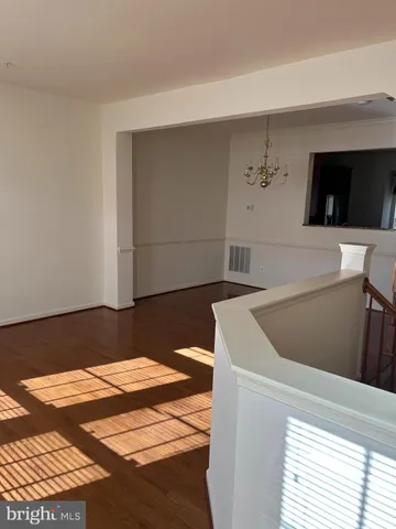 a kitchen with kitchen island granite countertop wooden cabinets a refrigerator and a sink