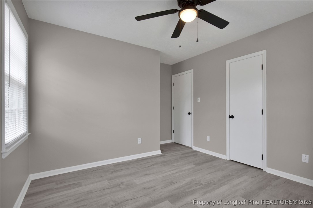 382 Saddle Ridge Road Fayetteville, NC 28311 - Photo 11 of 22 an empty room with wooden floor ceiling fan and window