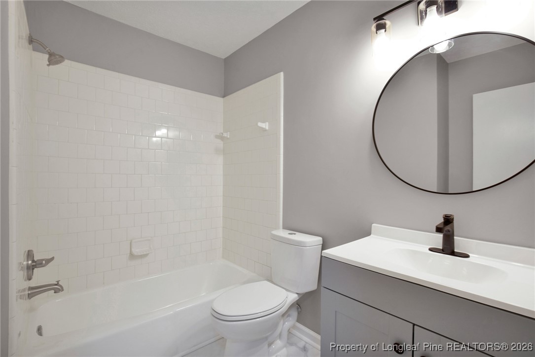 382 Saddle Ridge Road Fayetteville, NC 28311 - Photo 12 of 22 a bathroom with a sink a toilet and a mirror