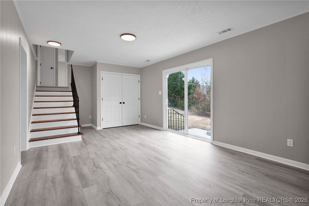 382 Saddle Ridge Road Fayetteville, NC 28311 - Photo 13 of 22 an empty room with wooden floor and windows