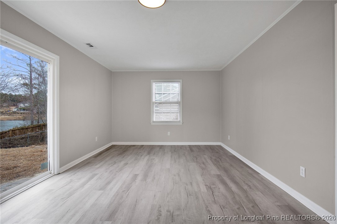 382 Saddle Ridge Road Fayetteville, NC 28311 - Photo 18 of 22 an empty room with wooden floor and windows