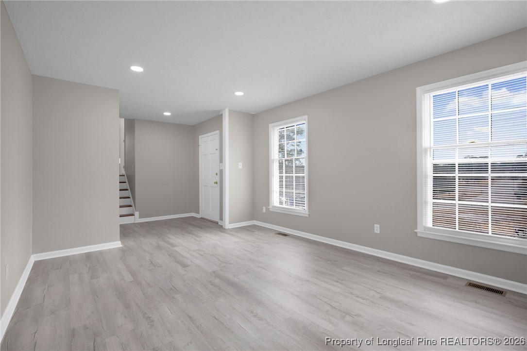 382 Saddle Ridge Road Fayetteville, NC 28311 - Photo 2 of 22 a view of an empty room with a window and wooden floor