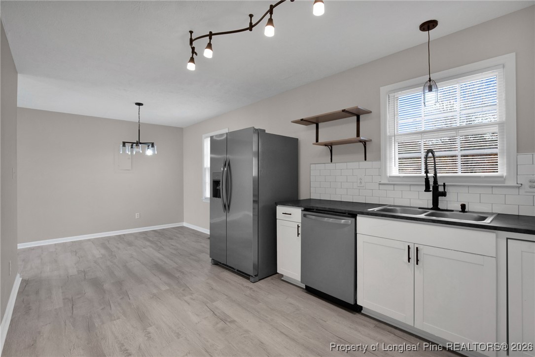 382 Saddle Ridge Road Fayetteville, NC 28311 - Photo 3 of 22 a kitchen with stainless steel appliances granite countertop a refrigerator a sink and white cabinets
