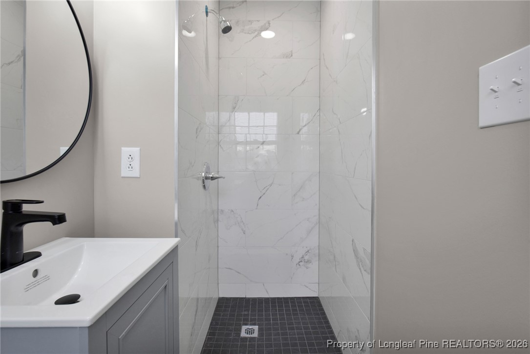 382 Saddle Ridge Road Fayetteville, NC 28311 - Photo 10 of 22 a bathroom with a sink a shower and a mirror