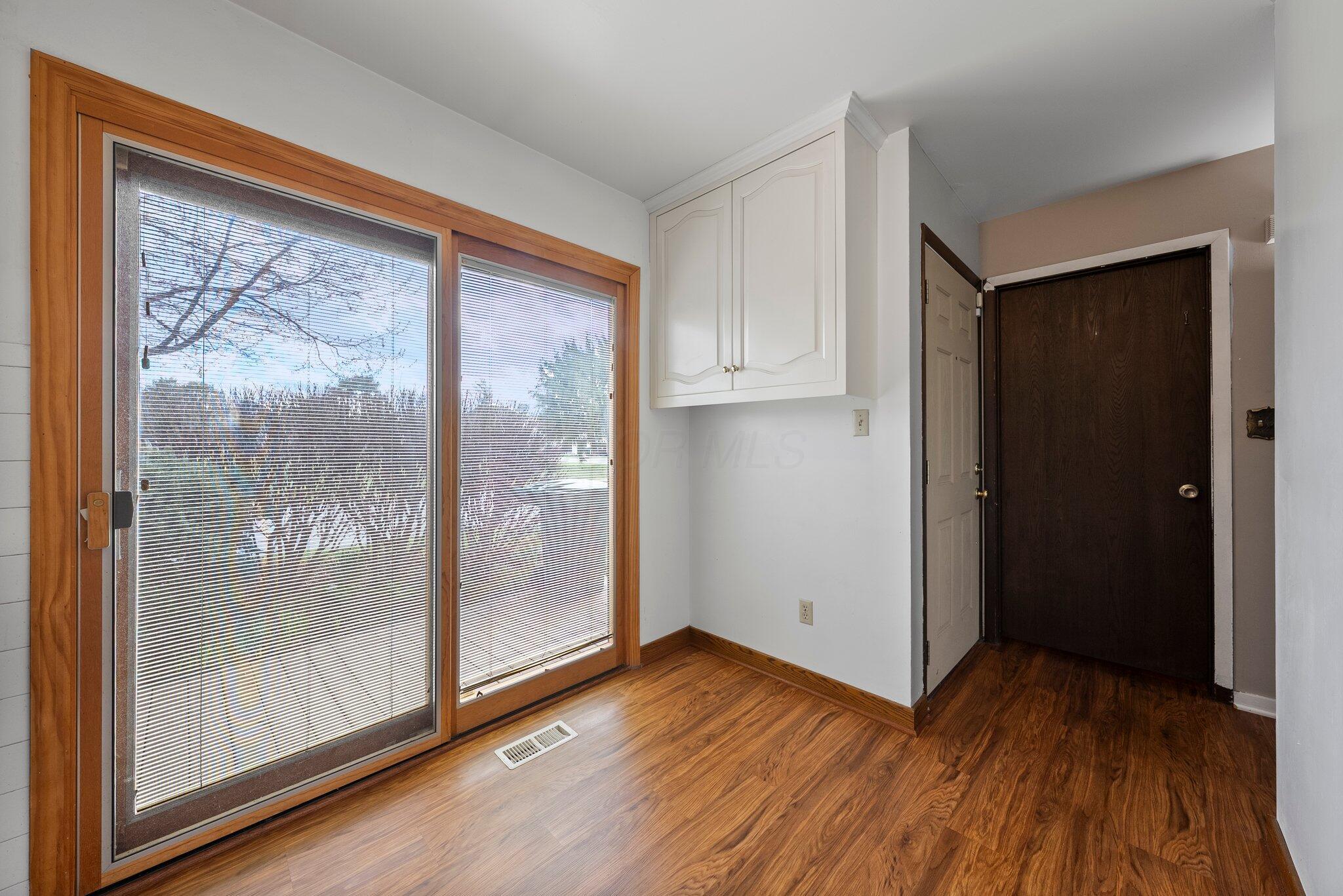 2052 Quail Ridge Street Columbus, OH 43229 - Photo 6 of 31 sliding doors with blinds in glass in kitchen
