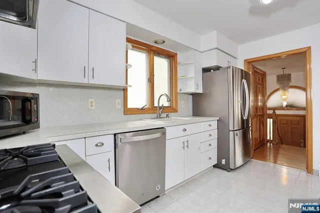 a kitchen with white cabinets and a stove