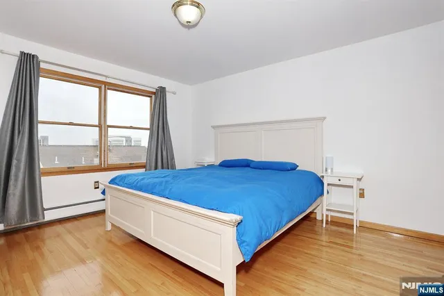 a bed sitting in a room next to a window