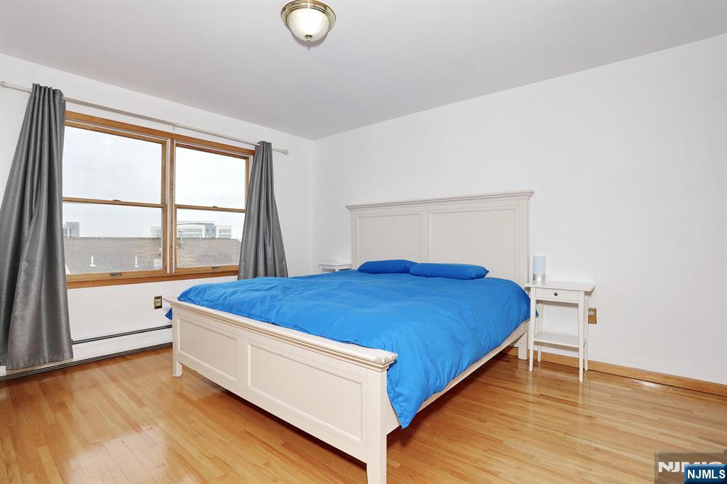 140 Prospect Street Hasbrouck Heights, NJ 07604 - Photo 14 of 28 a bed sitting in a room next to a window