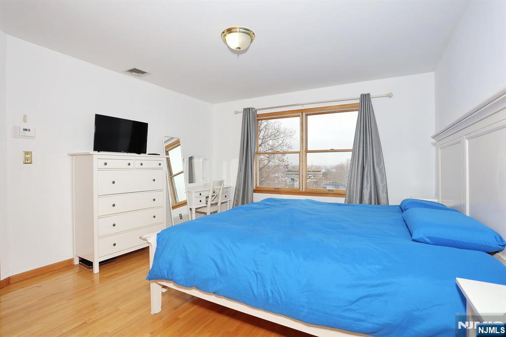 140 Prospect Street Hasbrouck Heights, NJ 07604 - Photo 15 of 28 a bedroom with a bed and a television