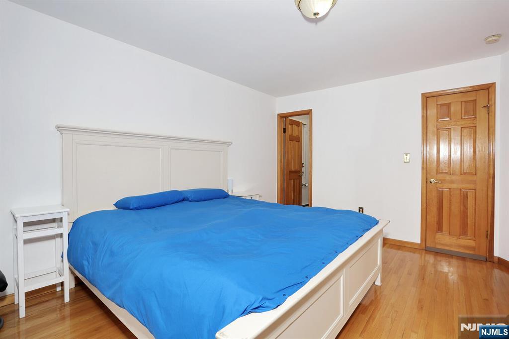 140 Prospect Street Hasbrouck Heights, NJ 07604 - Photo 16 of 28 a bedroom with a bed and a wooden floor
