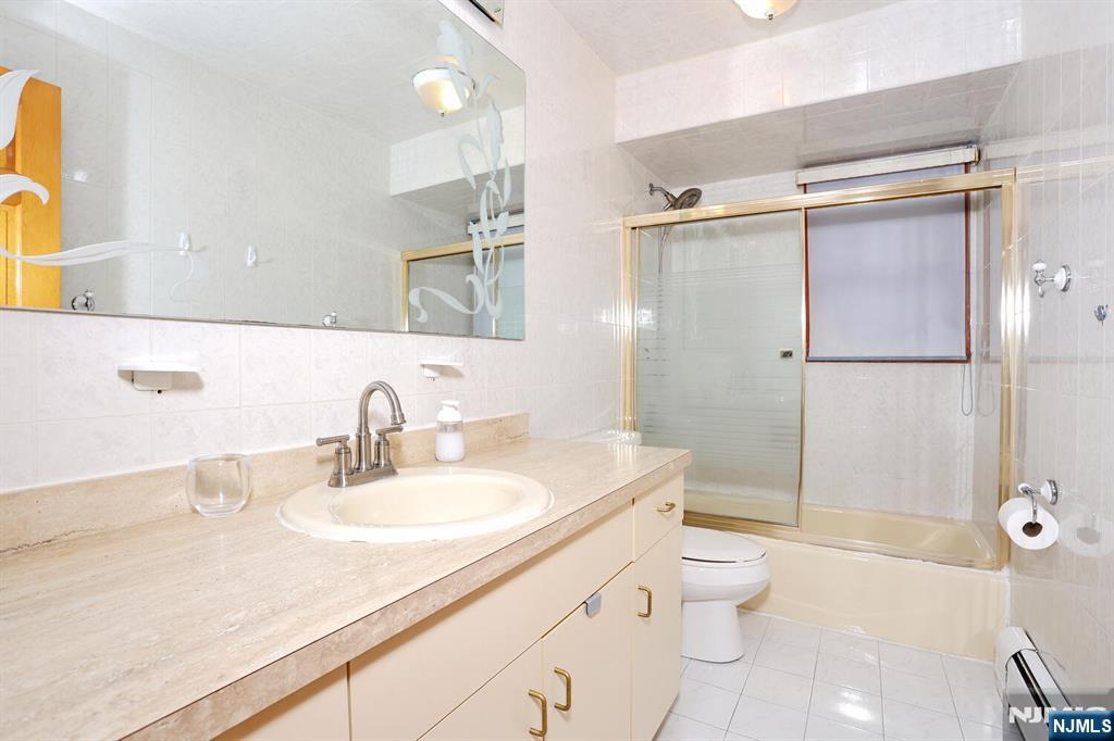 140 Prospect Street Hasbrouck Heights, NJ 07604 - Photo 23 of 28 a bathroom with a granite countertop sink toilet and shower