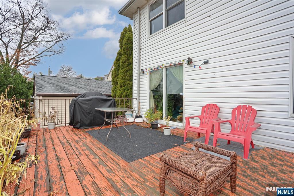 140 Prospect Street Hasbrouck Heights, NJ 07604 - Photo 26 of 28 a view of a patio with wooden table and chairs