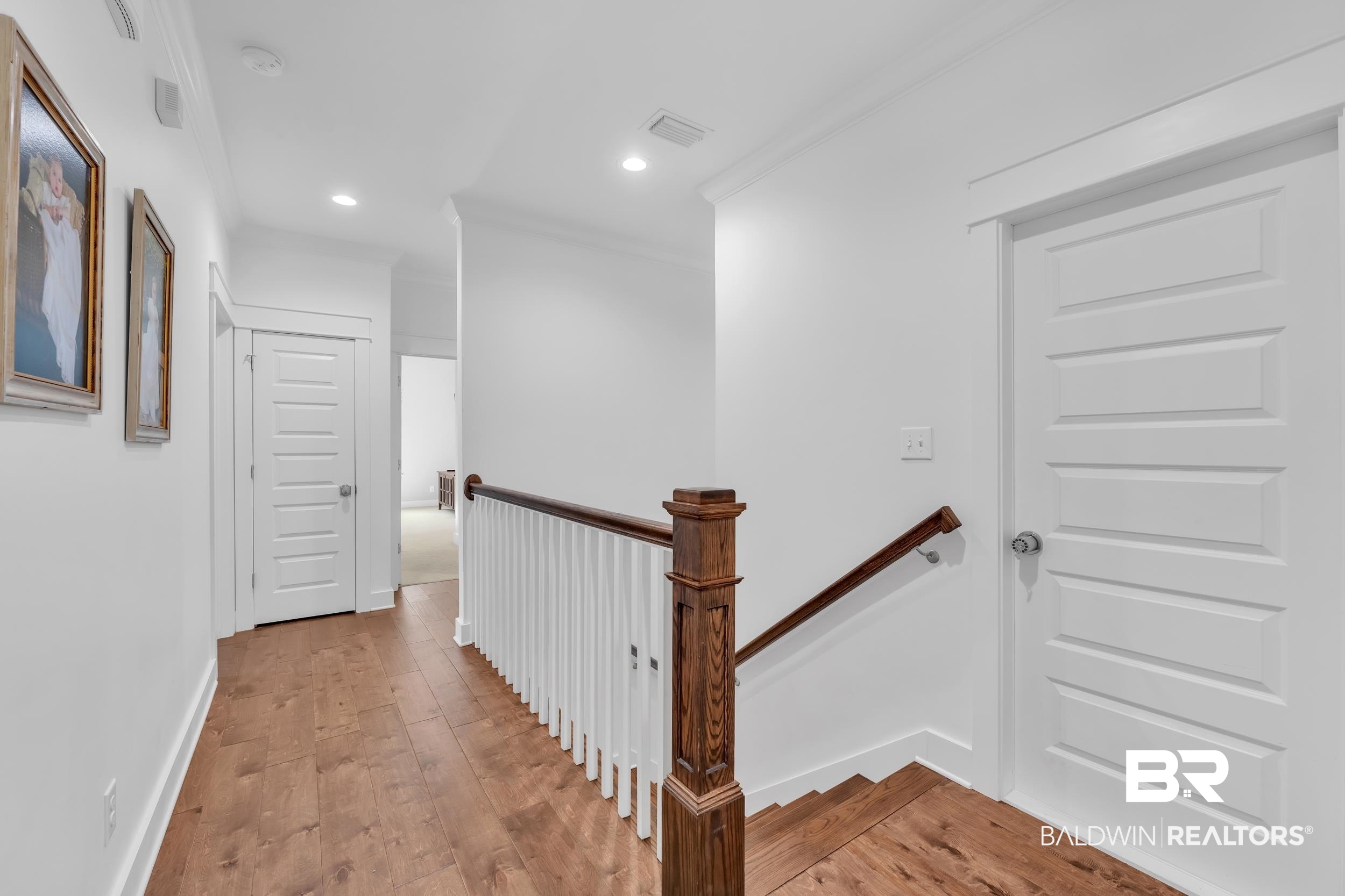 14531 Styx River Road Stapleton, AL 36578 - Photo 28 of 50 Hall with an upstairs landing, light wood-style floors, recessed lighting, ornamental molding, and baseboards