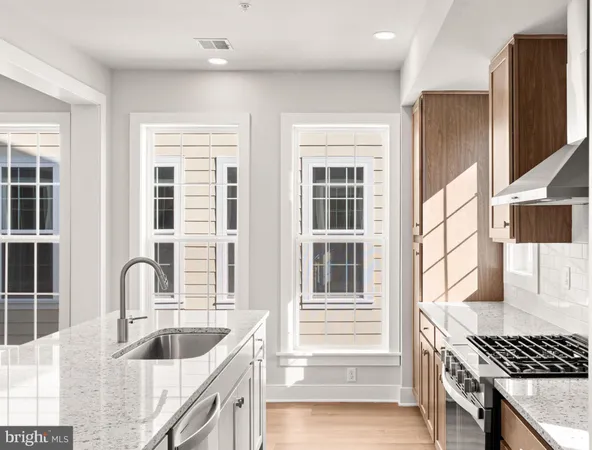 a kitchen with granite countertop a stove and a sink