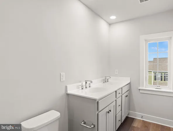 a bathroom with a sink a toilet and vanity