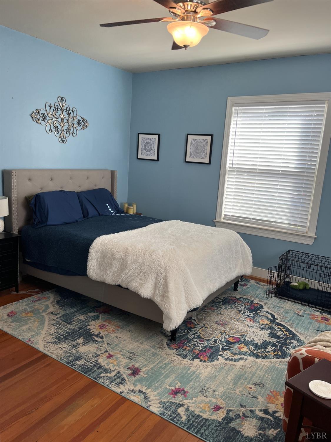 9710 Forest Road Goode, VA 24556 - Photo 17 of 49 a bedroom with a bed and wooden floor