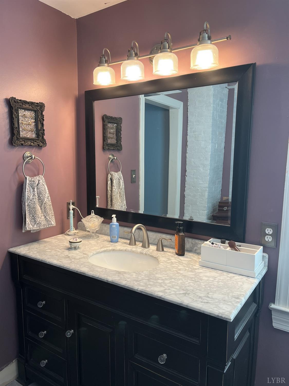 9710 Forest Road Goode, VA 24556 - Photo 23 of 49 a bathroom with a sink and a mirror