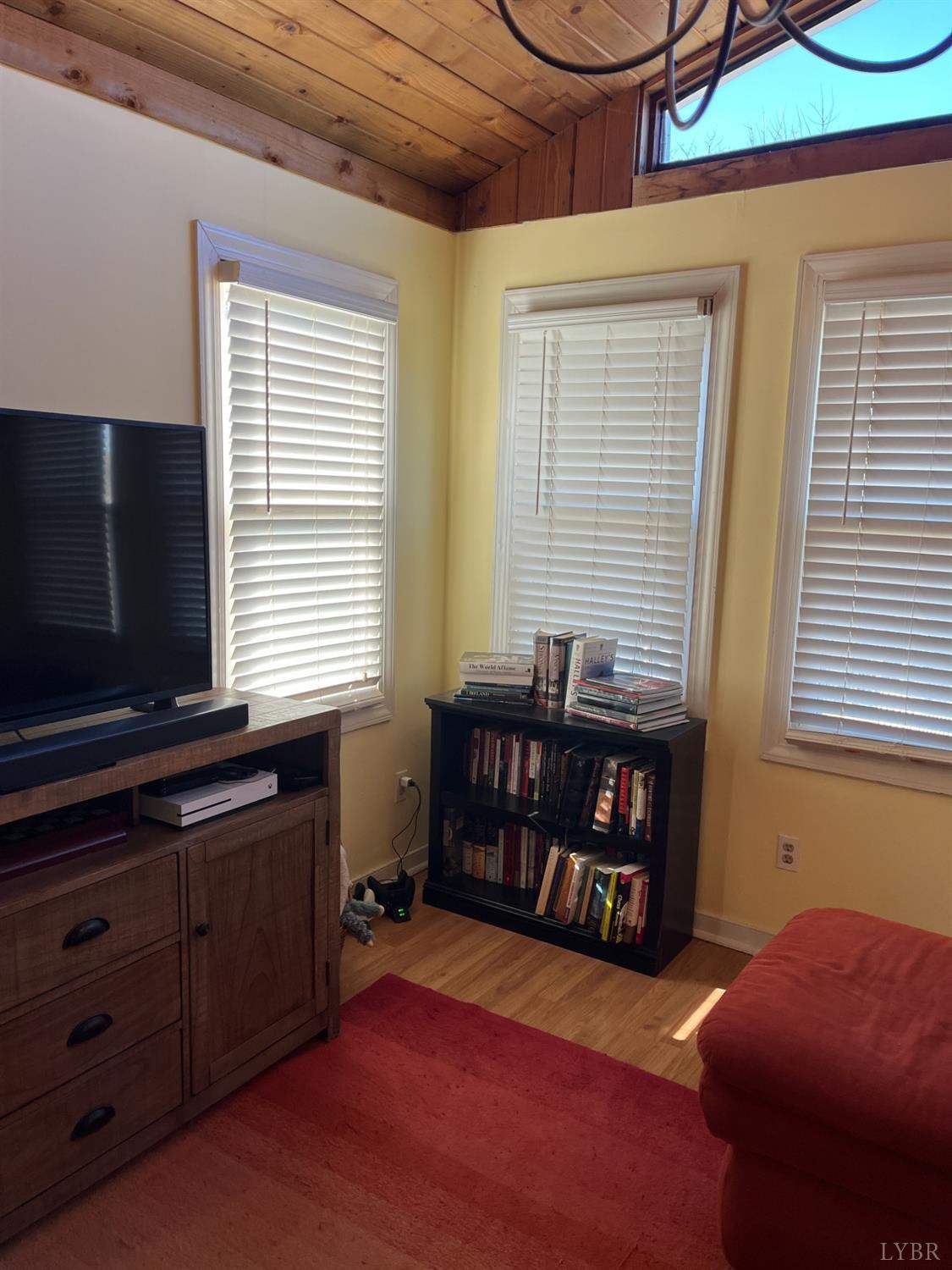 9710 Forest Road Goode, VA 24556 - Photo 9 of 49 a bedroom with a bed and a flat tv screen