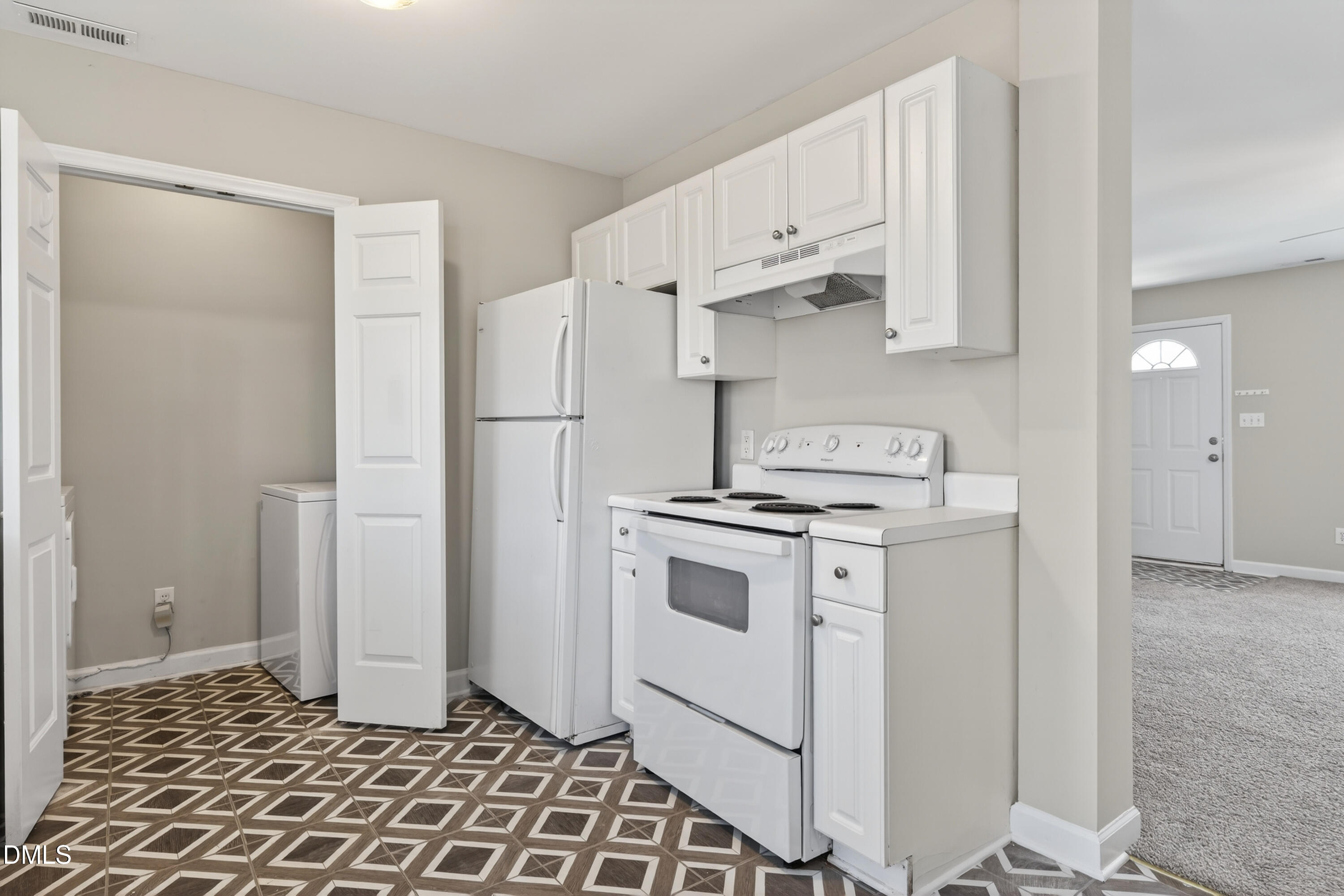 1601 Briarmont Court Raleigh, NC 27610 - Photo 15 of 30 a kitchen with white cabinets and white appliances