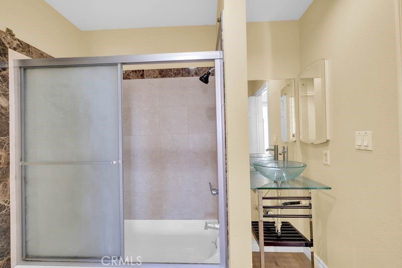 1781 Neil Armstrong Street, Unit 112 Montebello, CA 90640 - Photo 11 of 19 a bathroom with a shower and a mirror