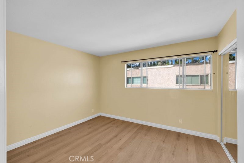 1781 Neil Armstrong Street, Unit 112 Montebello, CA 90640 - Photo 12 of 19 a view of an empty room with wooden floor and a window