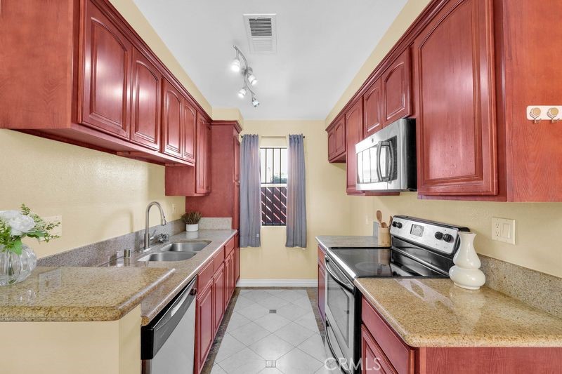 1781 Neil Armstrong Street, Unit 112 Montebello, CA 90640 - Photo 5 of 19 a kitchen with a sink stove and cabinets