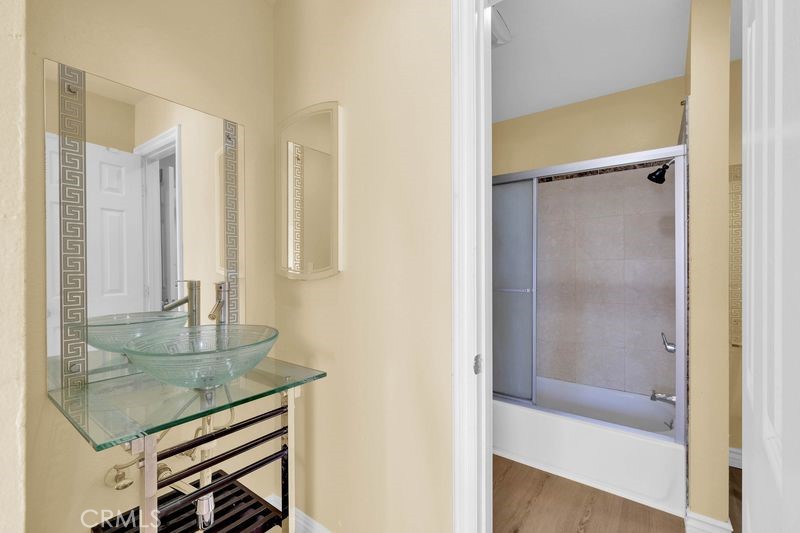 1781 Neil Armstrong Street, Unit 112 Montebello, CA 90640 - Photo 9 of 19 a bathroom with a granite countertop sink a mirror and shower
