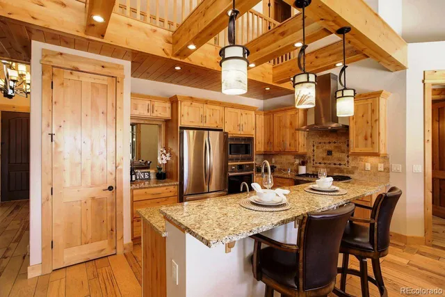 a kitchen with a table chairs refrigerator and cabinets