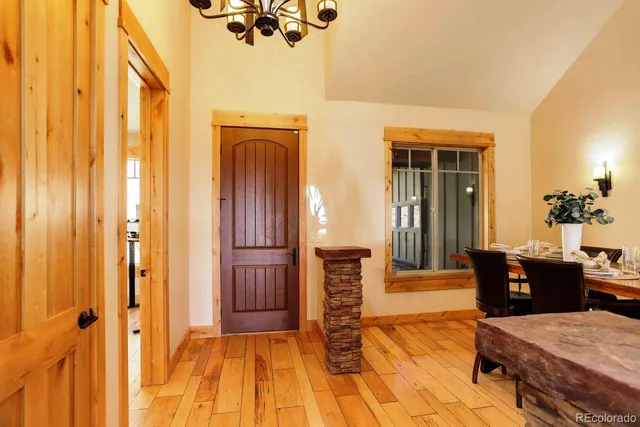 a view of a livingroom with furniture wooden floor and front door