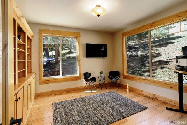 a living room with furniture rug and a table