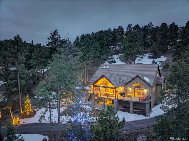 an aerial view of a house with a swimming pool outdoor seating and yard