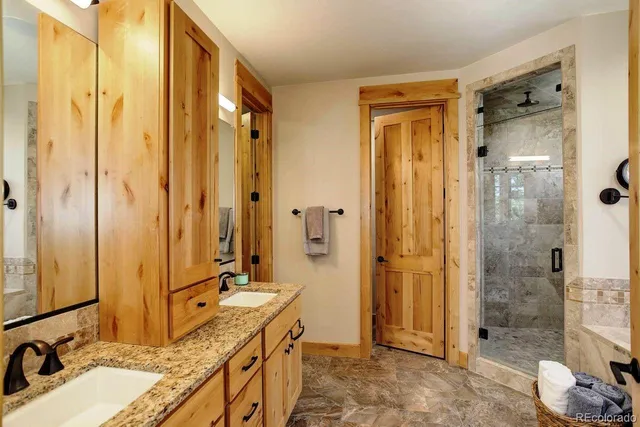 a bathroom with a double vanity sink mirror double and shower