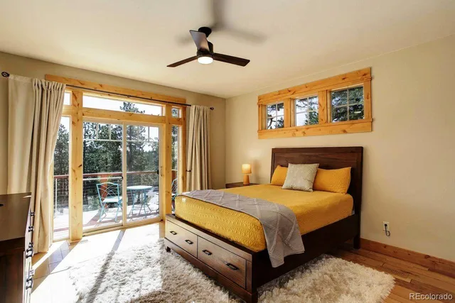 a bedroom with a large bed and a large window