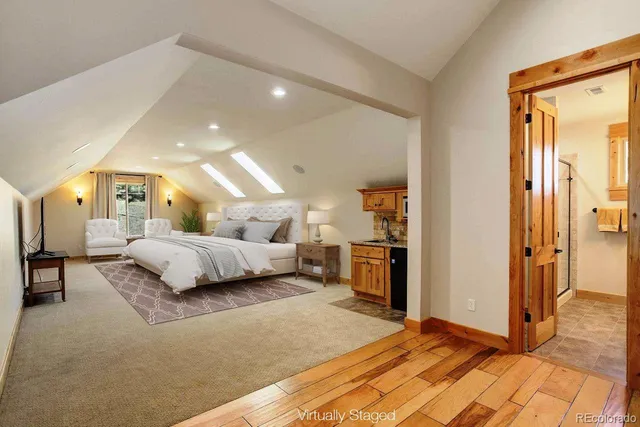 a bedroom with a large bed and a chandelier