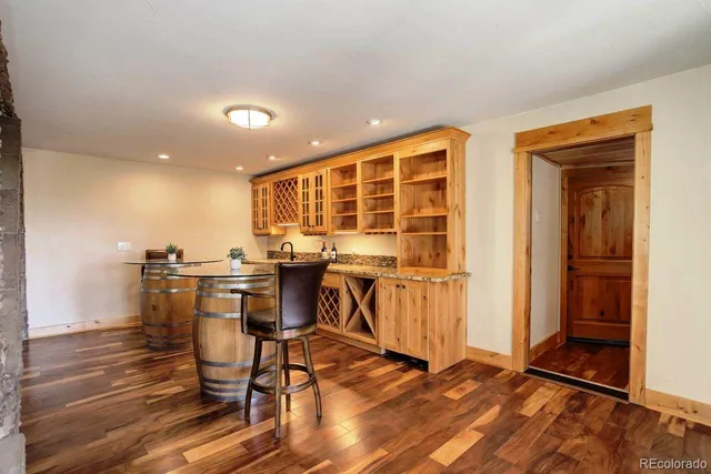 a view of a kitchen with a dining table chairs and entryway