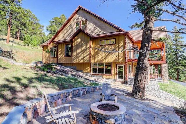 a aerial view of a house with a yard and balcony