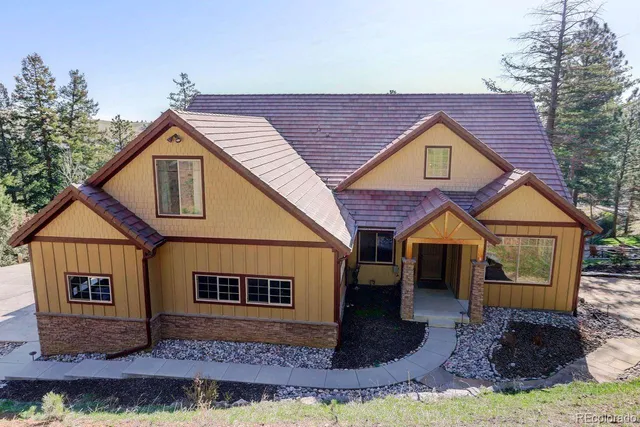 a view of a house with wooden fence