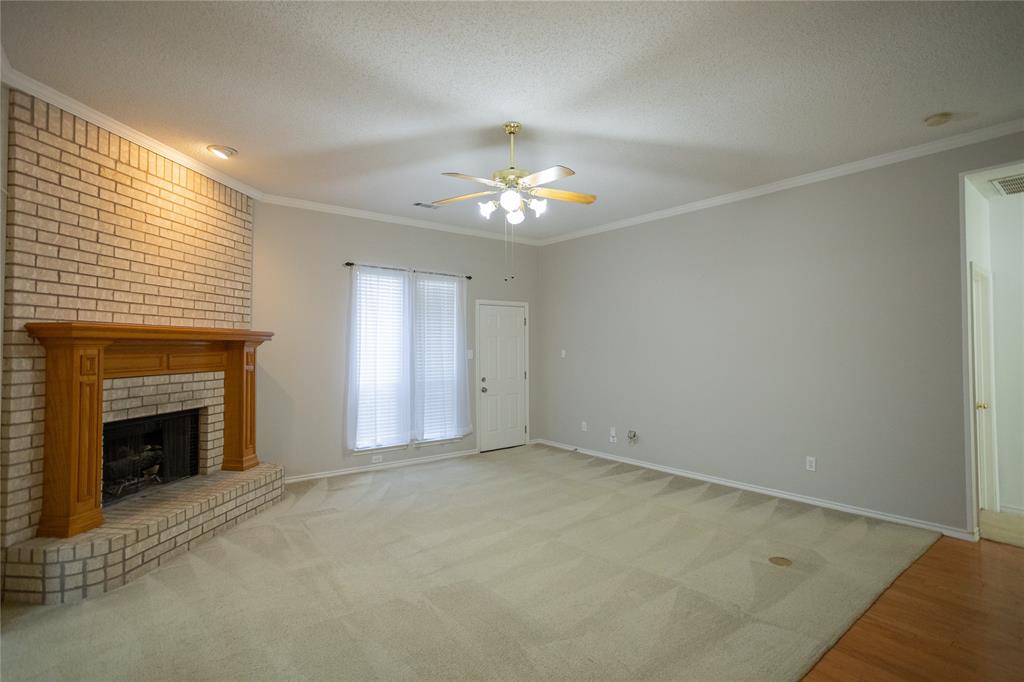809 Sterling Court Allen, TX 75002 - Photo 14 of 16 an empty room with windows and fireplace