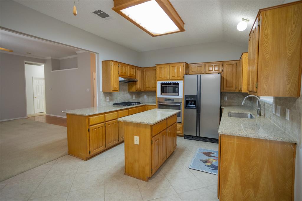 809 Sterling Court Allen, TX 75002 - Photo 16 of 16 a kitchen with stainless steel appliances granite countertop a stove top oven a refrigerator a sink and dishwasher