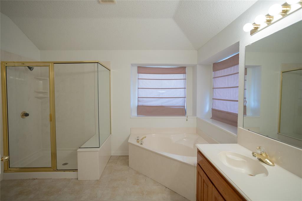 809 Sterling Court Allen, TX 75002 - Photo 4 of 16 a bathroom with a granite countertop bathtub shower sink vanity and toilet