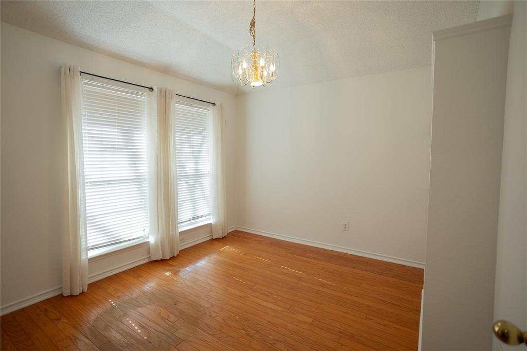809 Sterling Court Allen, TX 75002 - Photo 8 of 16 a view of an empty room with wooden floor and a window