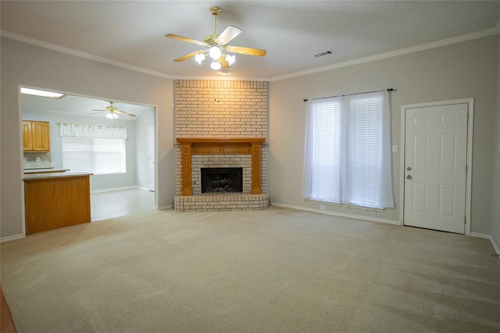 809 Sterling Court Allen, TX 75002 - Photo 10 of 16 an empty room with windows fireplace and a sink