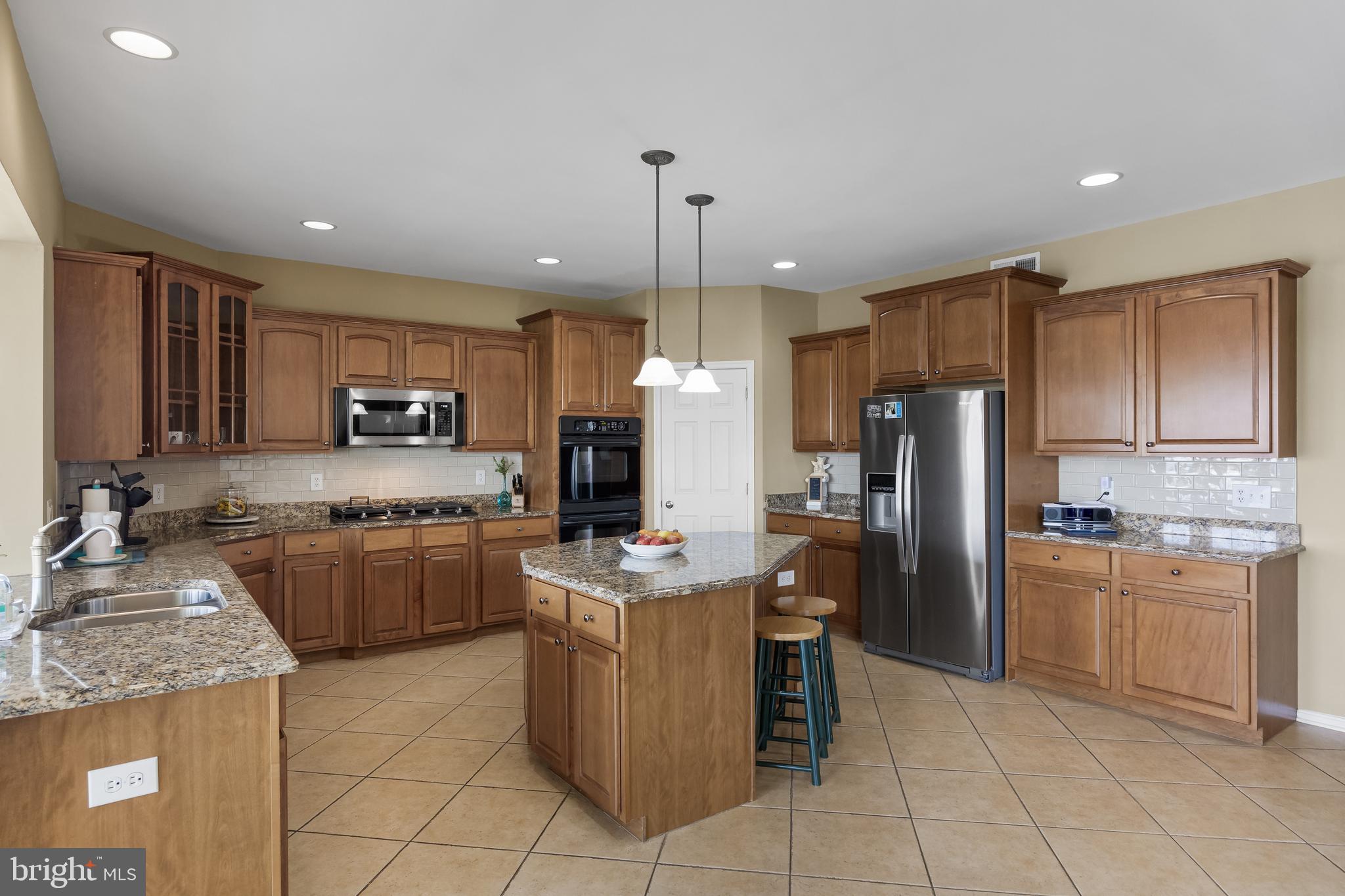 23 Mullen Drive Sicklerville, NJ 08081 - Photo 19 of 73 a kitchen with stainless steel appliances granite countertop a stove top oven a refrigerator a sink and dishwasher