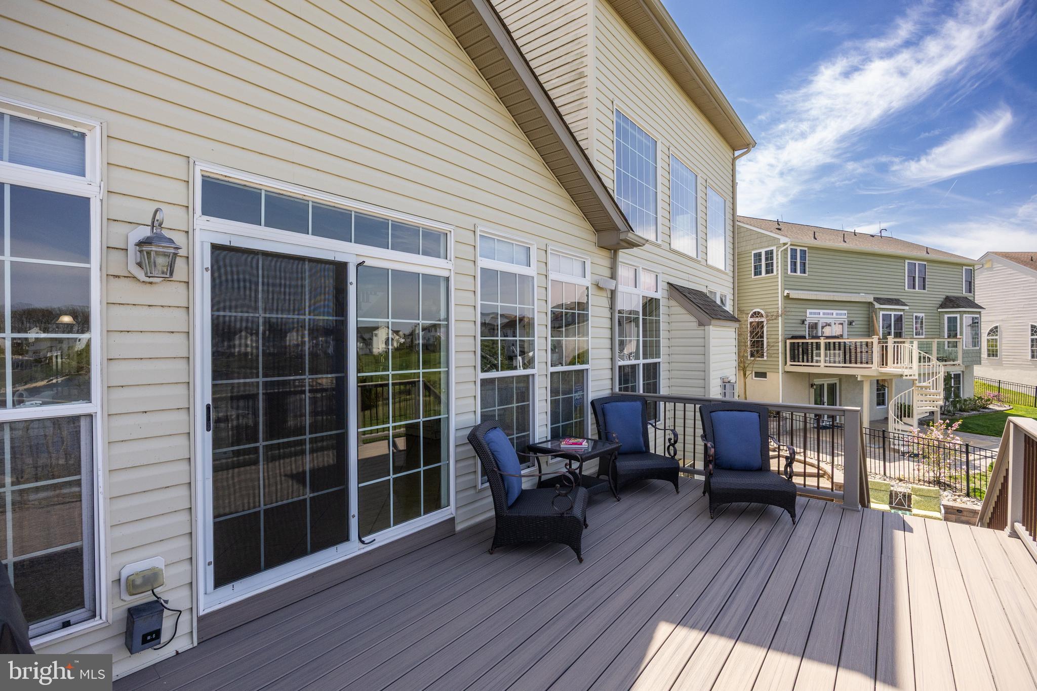 23 Mullen Drive Sicklerville, NJ 08081 - Photo 52 of 73 a view of a deck with couches floor to ceiling window with wooden floor
