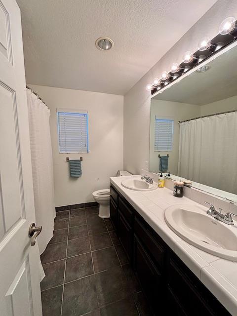 820 Talbot Drive Hollister, CA 95023 - Photo 11 of 27 a bathroom with a double vanity sink a toilet and a mirror