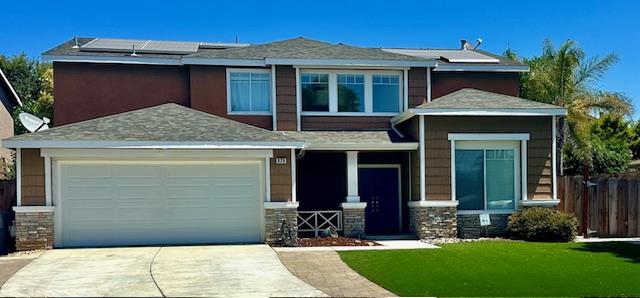 820 Talbot Drive Hollister, CA 95023 - Photo 2 of 27 a front view of a house with a garden and yard